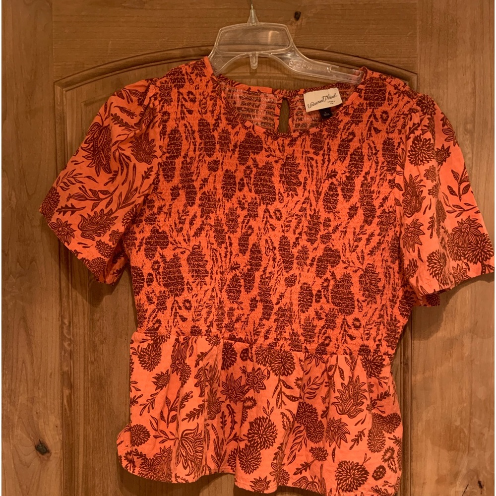 Beautiful vibrant colors. Smocked peplum top.